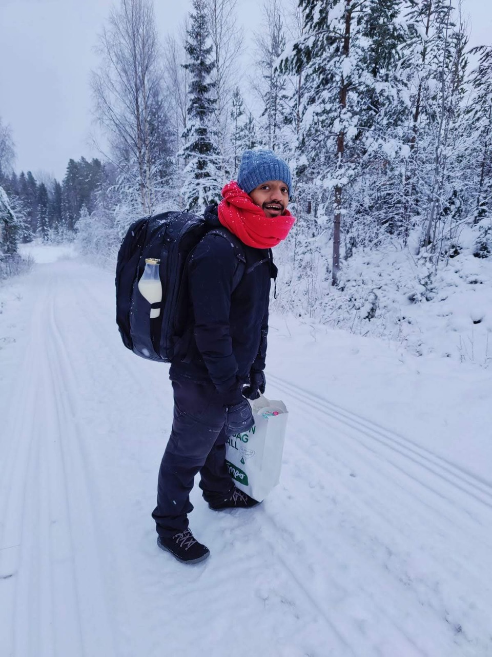 picture of me walking in the snow with the peak design backpack