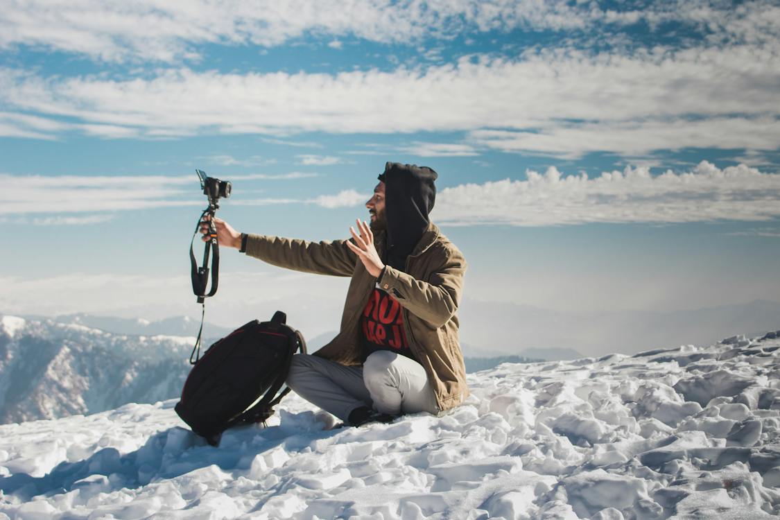 Man taking a Video of Himself on a Snow Mountain