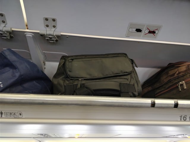 nomatic travel bag in overhead cabin